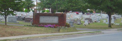 Westwood Cemetery Sign. Sign is made primarily of brick and encircled in summer flowers.